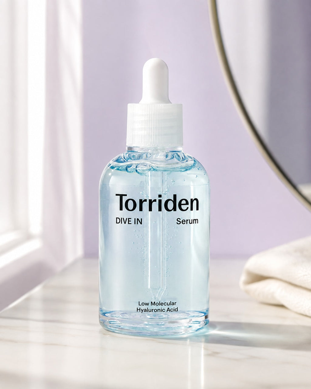 Torriden DIVE IN Serum on an ivory vanity with soft window light